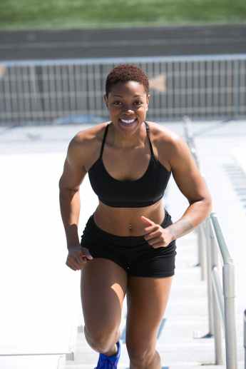 woman wearing black sports bra and jogger shorts smiling